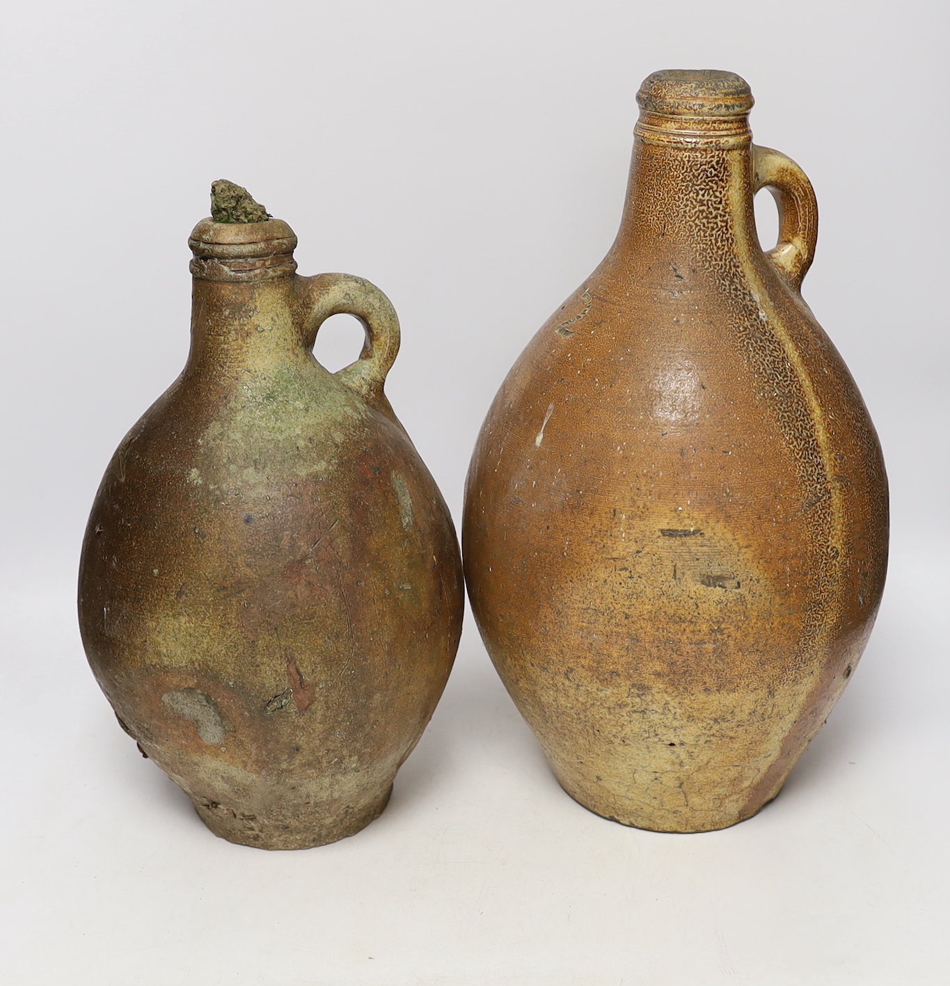 An 18th century German stoneware bellamine and another, 38cm